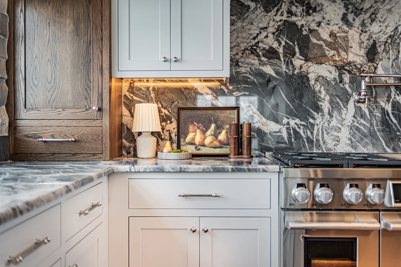 A kitchen with a marble backsplash staged by Style House